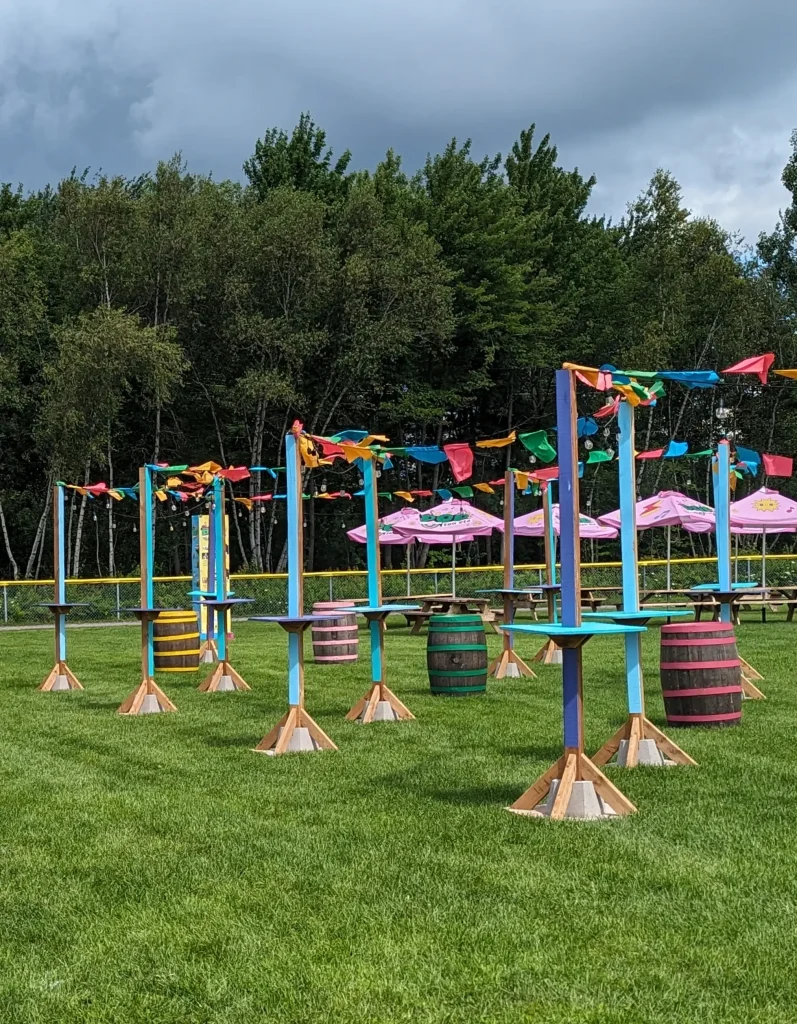 Mâts festifs et fanions multicolores avec tonneaux-tables, festival POP ton été Terrebonne
